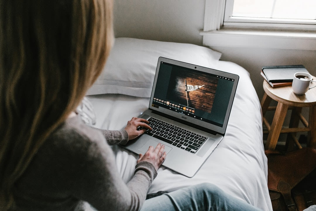 woman using gray laptop on bed on Skill Forge