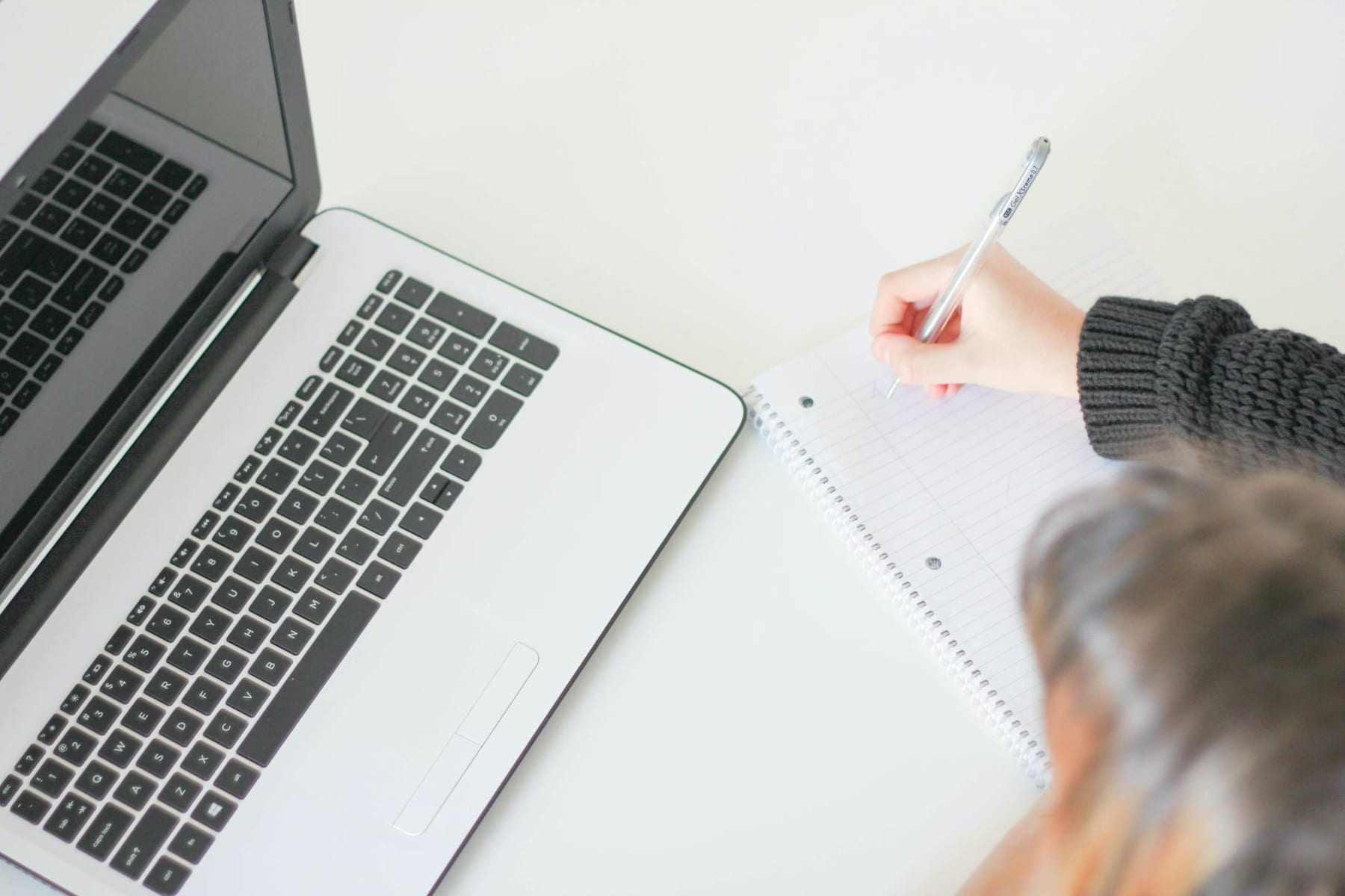 Casual home office setup with laptop and notebook, ideal for freelancers. on Skill Forge